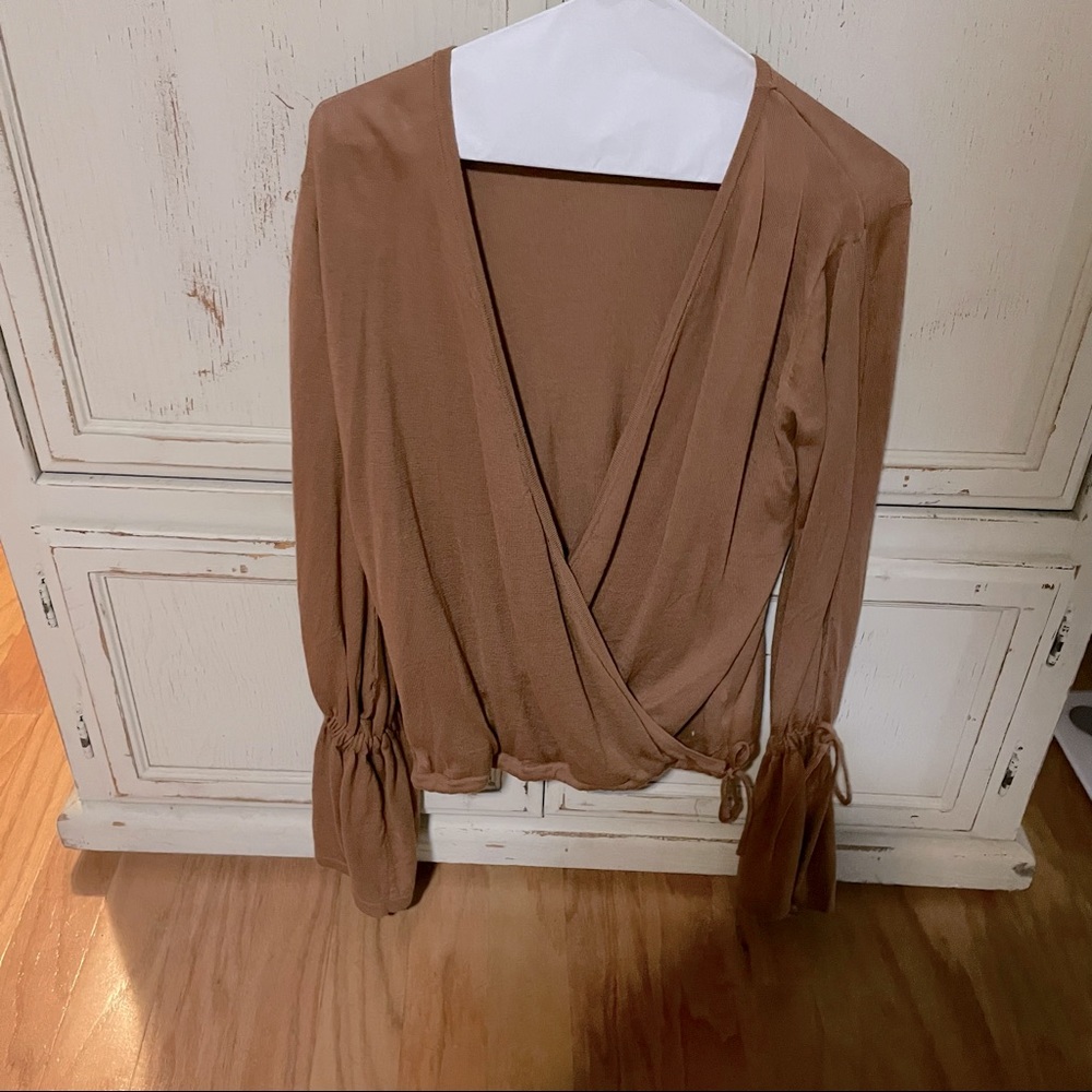 Woman’s low cut, wide open sleeve blouse
